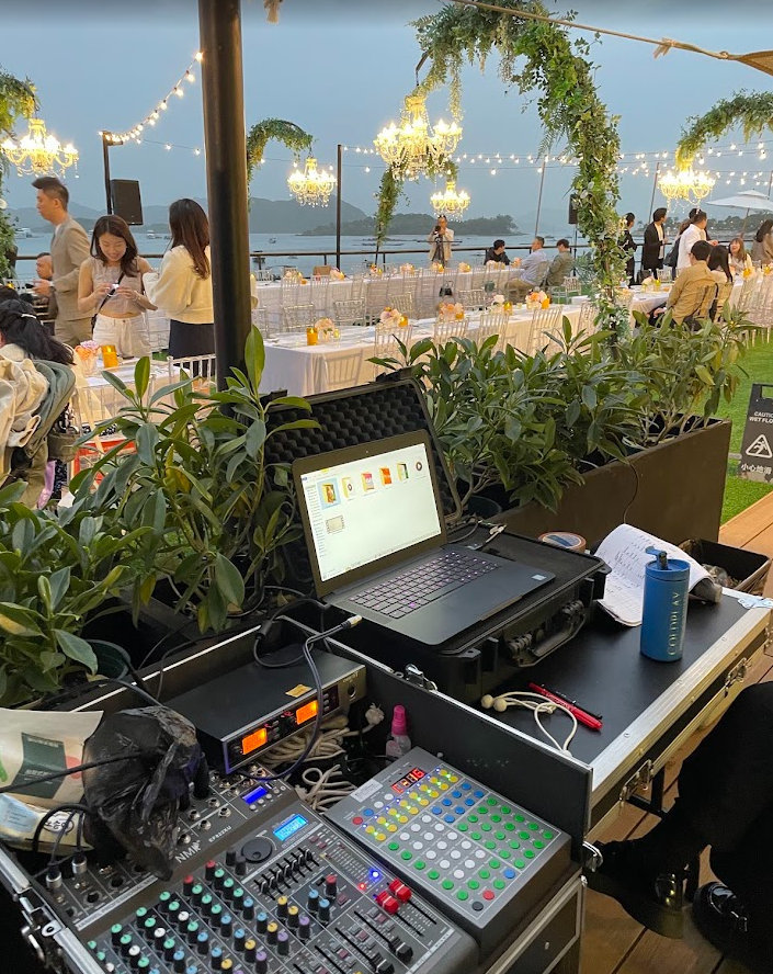Evening celebration lighting at a Goofy Waves waterfront wedding